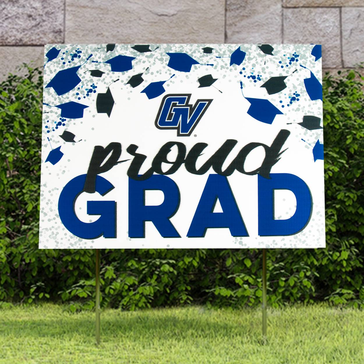 Proud GV Grad yard sign displayed in the grass with graphic of grad cap